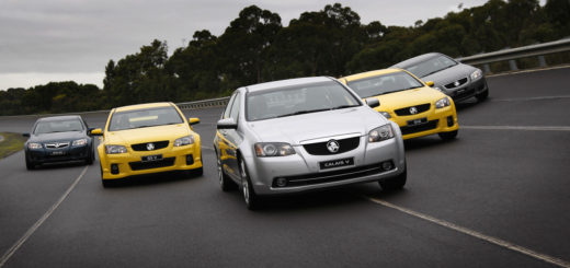 Five new autos on highway in flying V formation